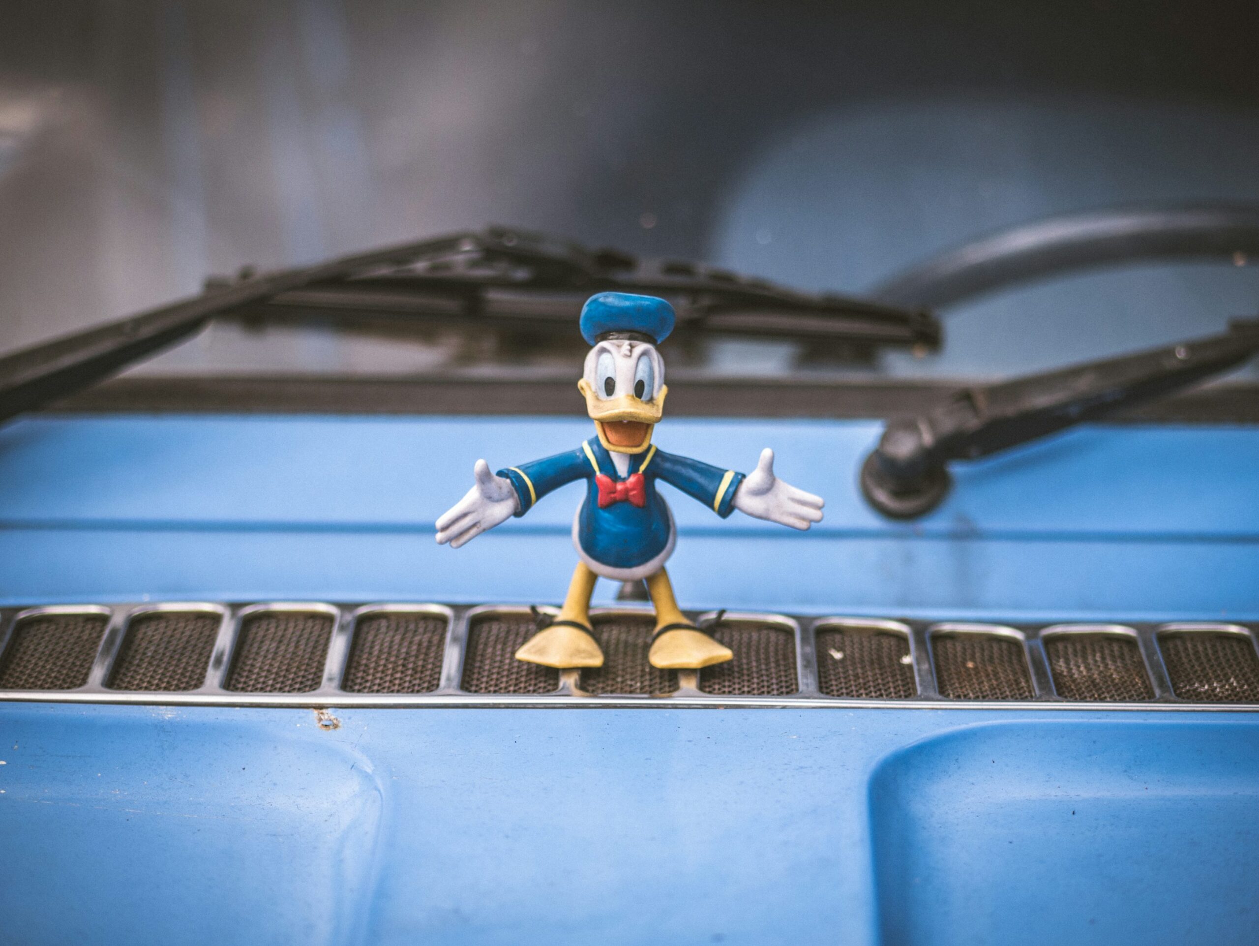 photo 1641421729997 1afa588eaad1 - Magvilla a mickey mouse figurine sitting on the hood of a car