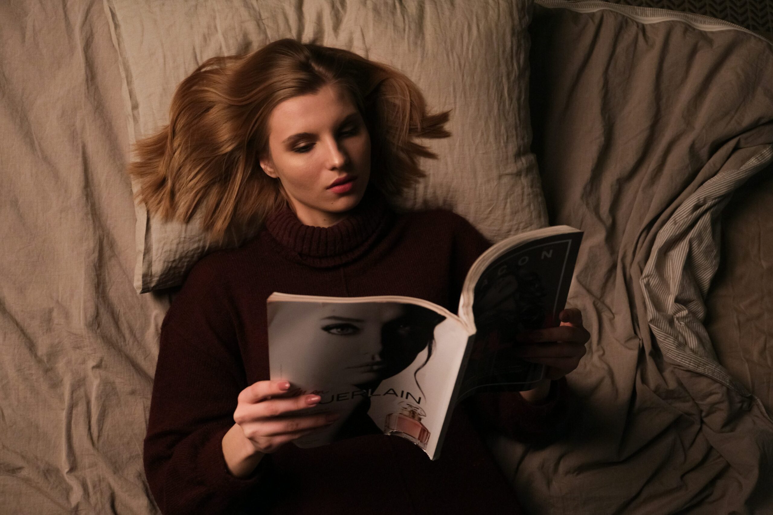 photo 1606724977658 4573c8cb3135 - Magvilla woman in gray sweater holding book