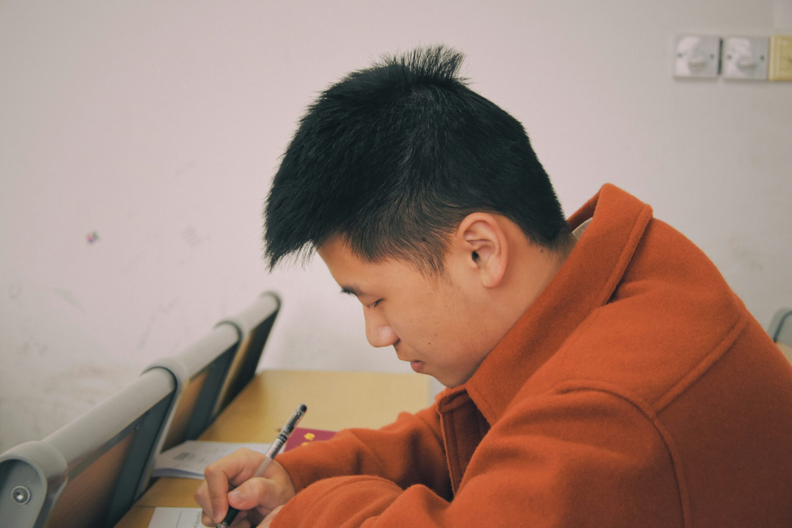 photo 1614492898637 435e0f87cef8 - Magvilla man in orange hoodie using smartphone